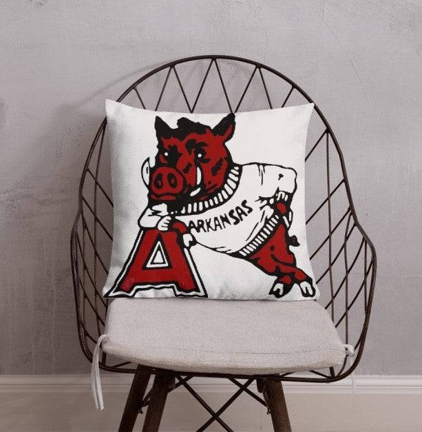 Arkansas Vintage 1950s Razorbacks Booster Club throw pillow on a chair.